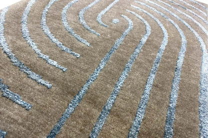 Designer rug with turquoise curved lines in a swirling pattern on a beige background
