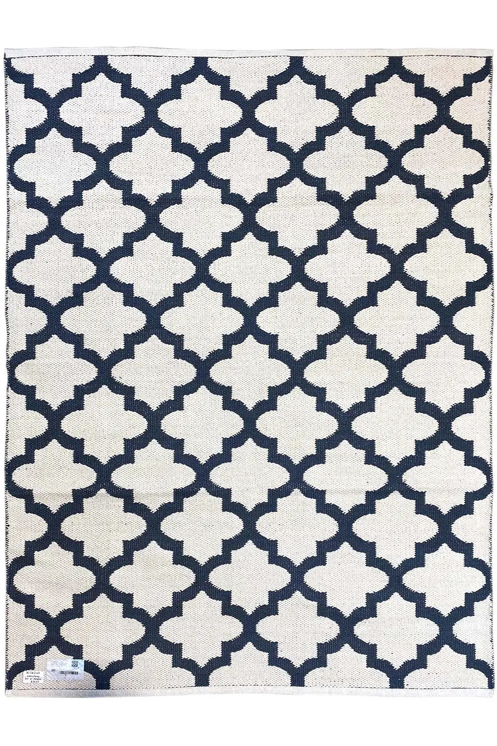 Rectangular kilim rug with a dark blue background and white geometric pattern