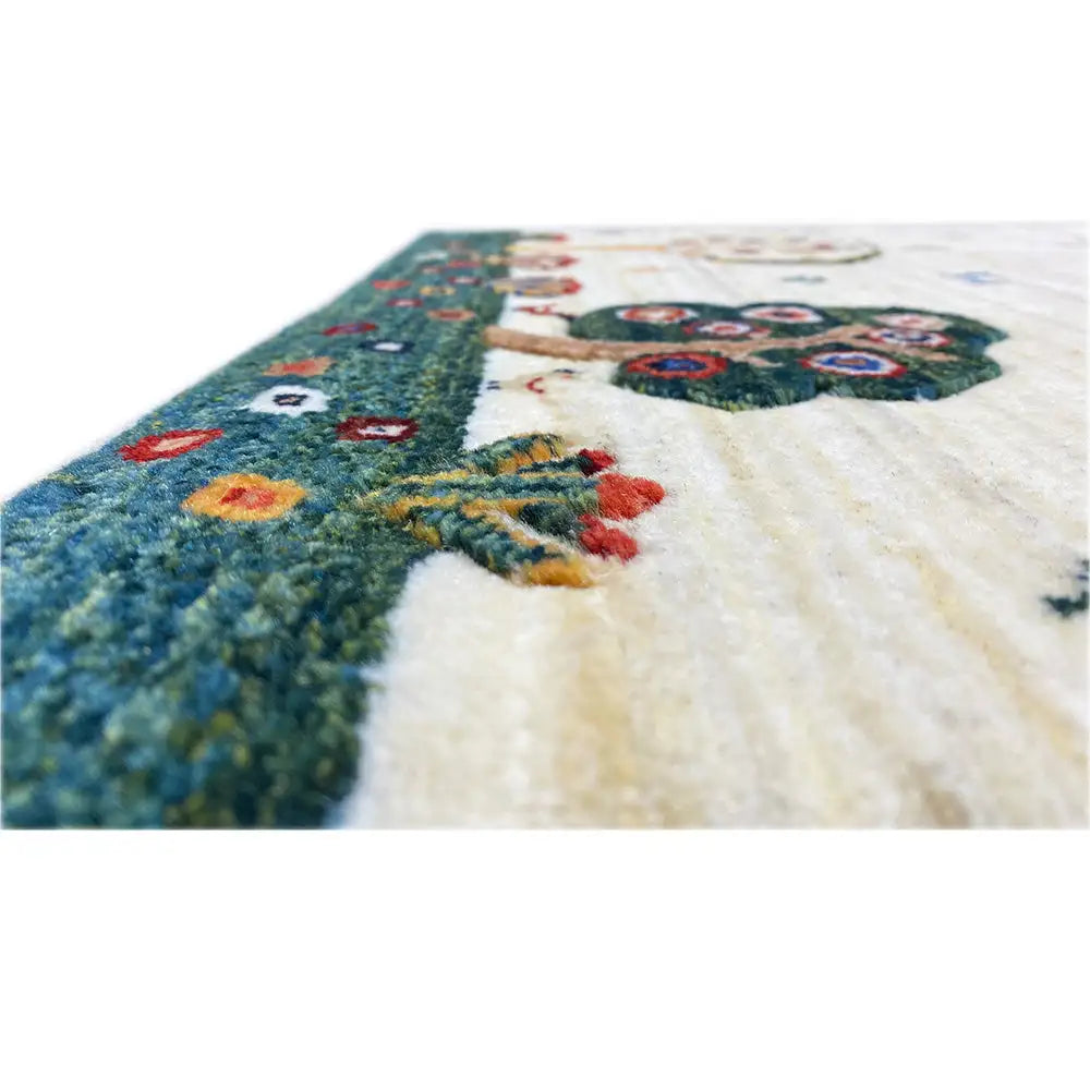 Close-up of Gabbeh rug, side corner with colorful motifs and soft pile