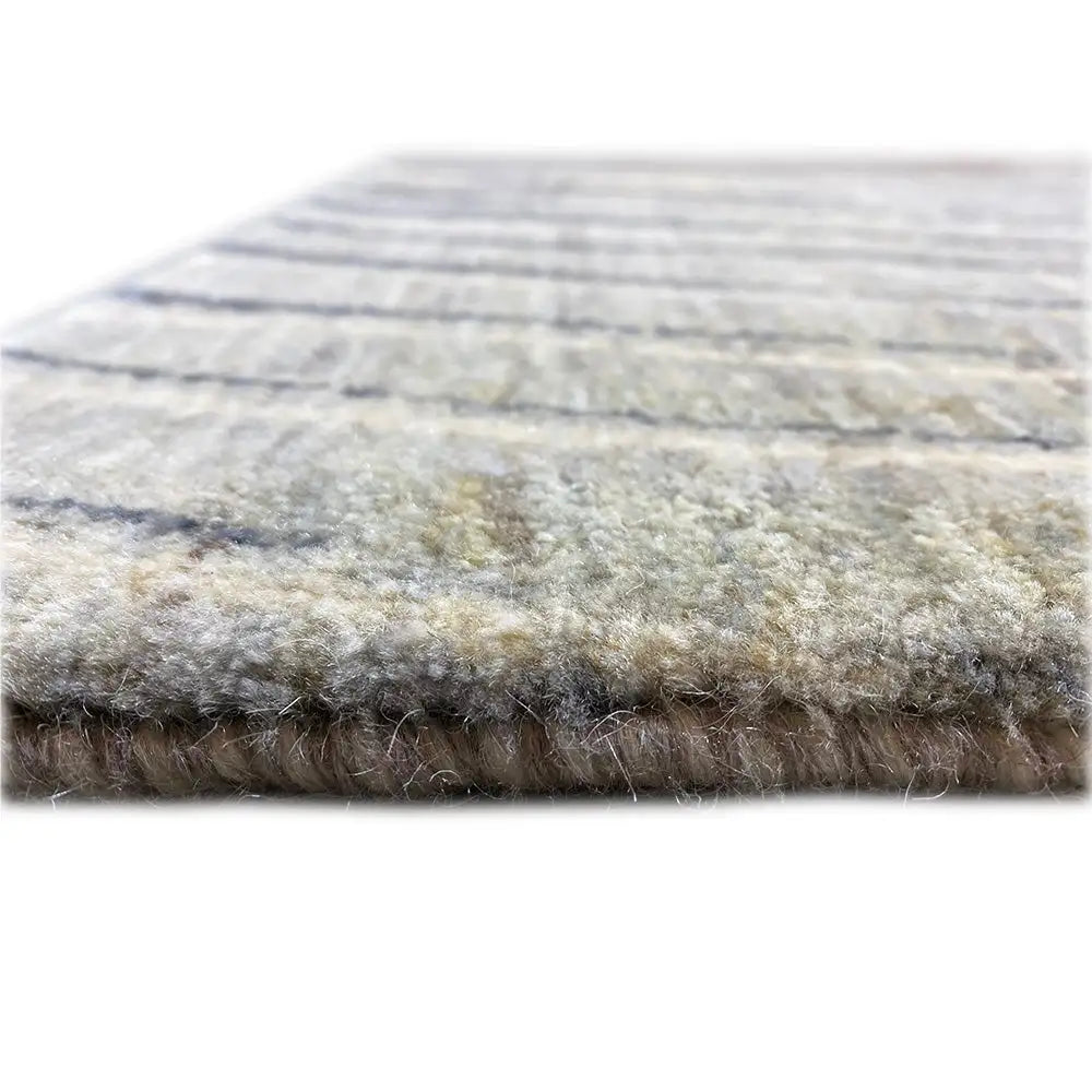 Back view of a Gabbeh rug with a beige pile and dark blue lines; edges with fringes