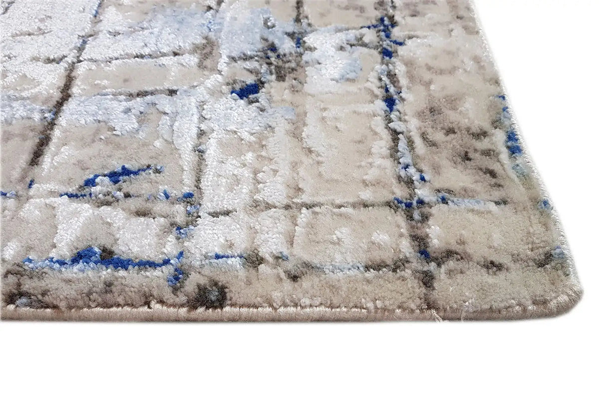 Carpet edge with light pile and blue grid pattern, detail
