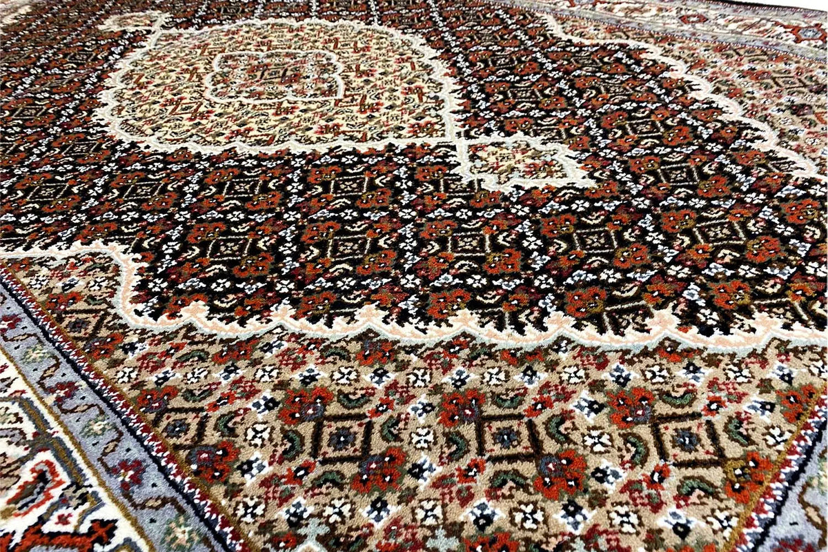Indo Tabriz rug detail: vine and medallion pattern, dark brown