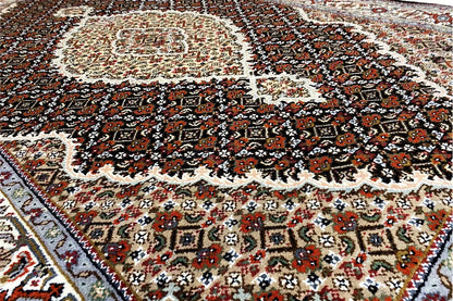 Indo Tabriz rug detail: vine and medallion pattern, dark brown