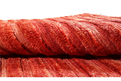 Close-up: ribbed pile texture in red, tightly woven threads