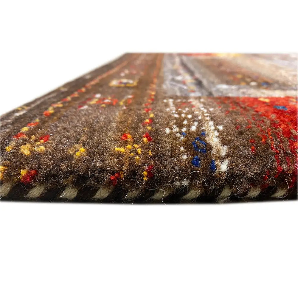 Gabbeh rug weave in detail: brown pile with colorful accents