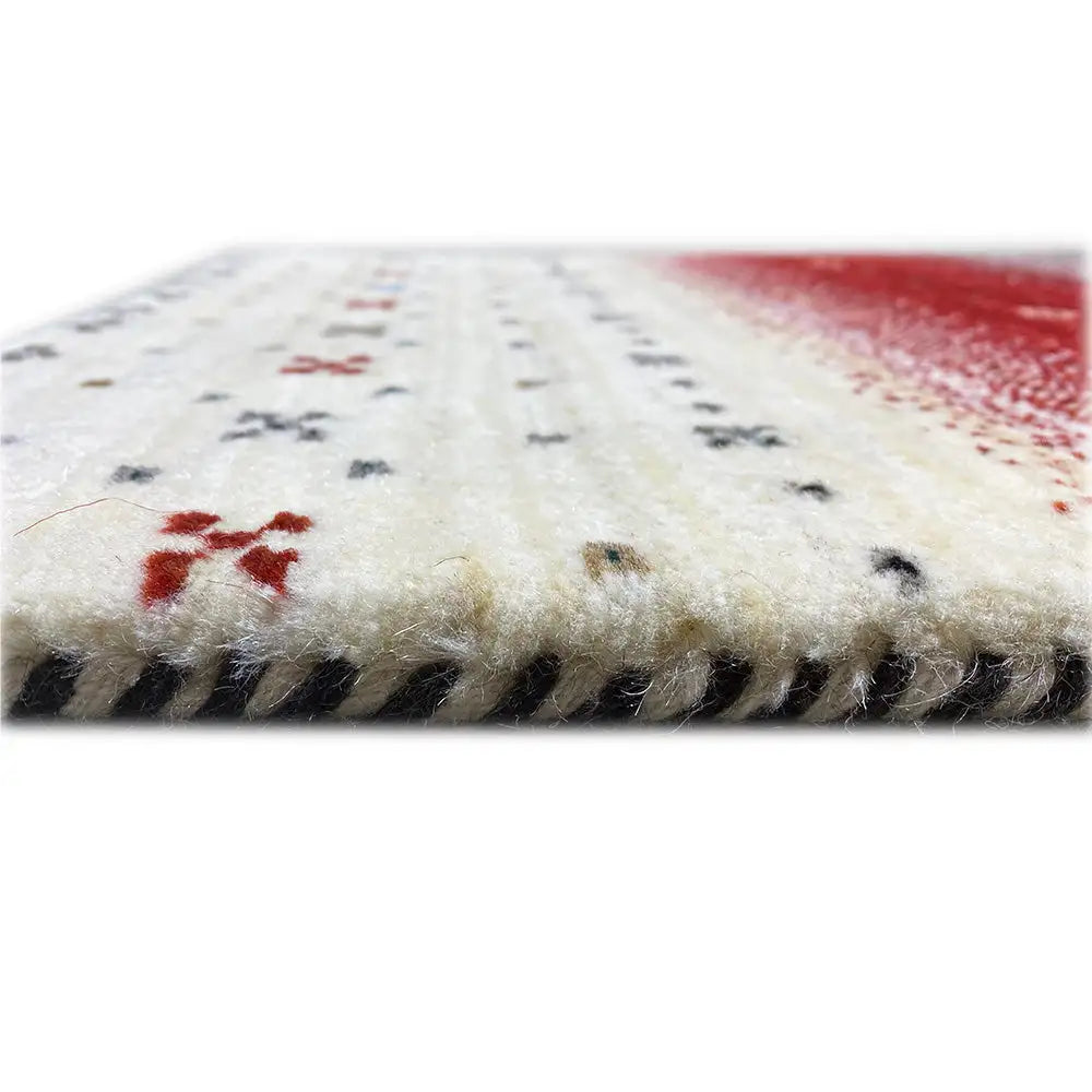 Gabbeh runner Lori, close-up with pile and fringe at the edge, cream-colored with red accents