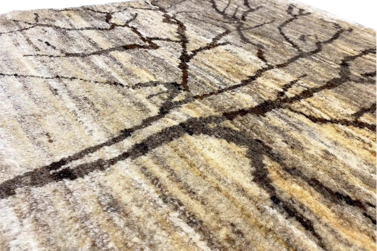 Gabbeh rug detail: black tree branches on a light, patterned pile