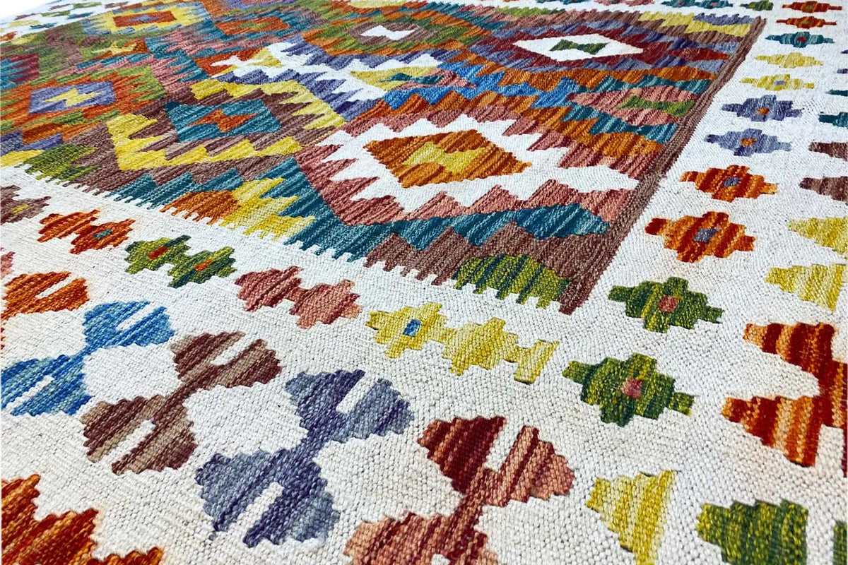 Kilim surface in detail: multicolored woven patterns on a light background