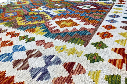 Kilim surface in detail: multicolored woven patterns on a light background
