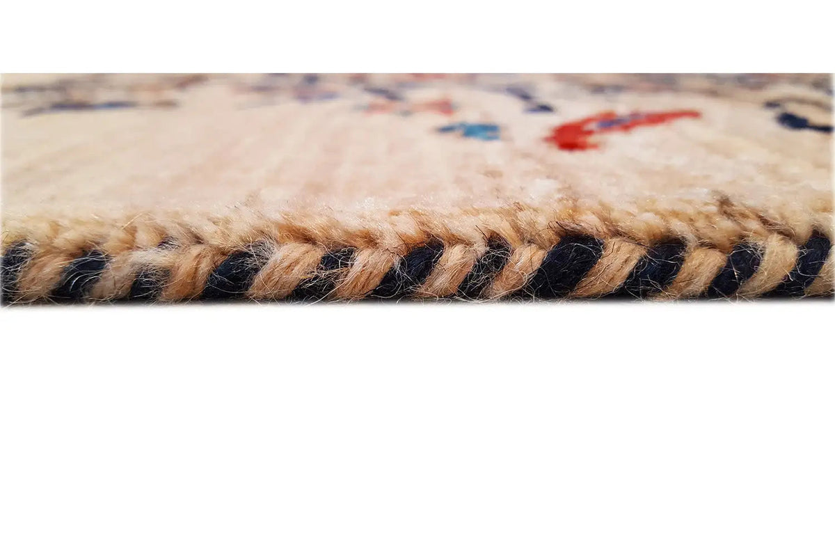 Carpet edge with fringe; beige pile and dark threads along the edge