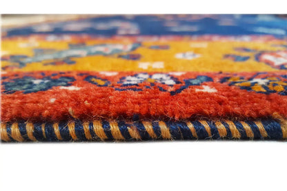 Rug edge with fringe and a multicolored border pattern along the edge