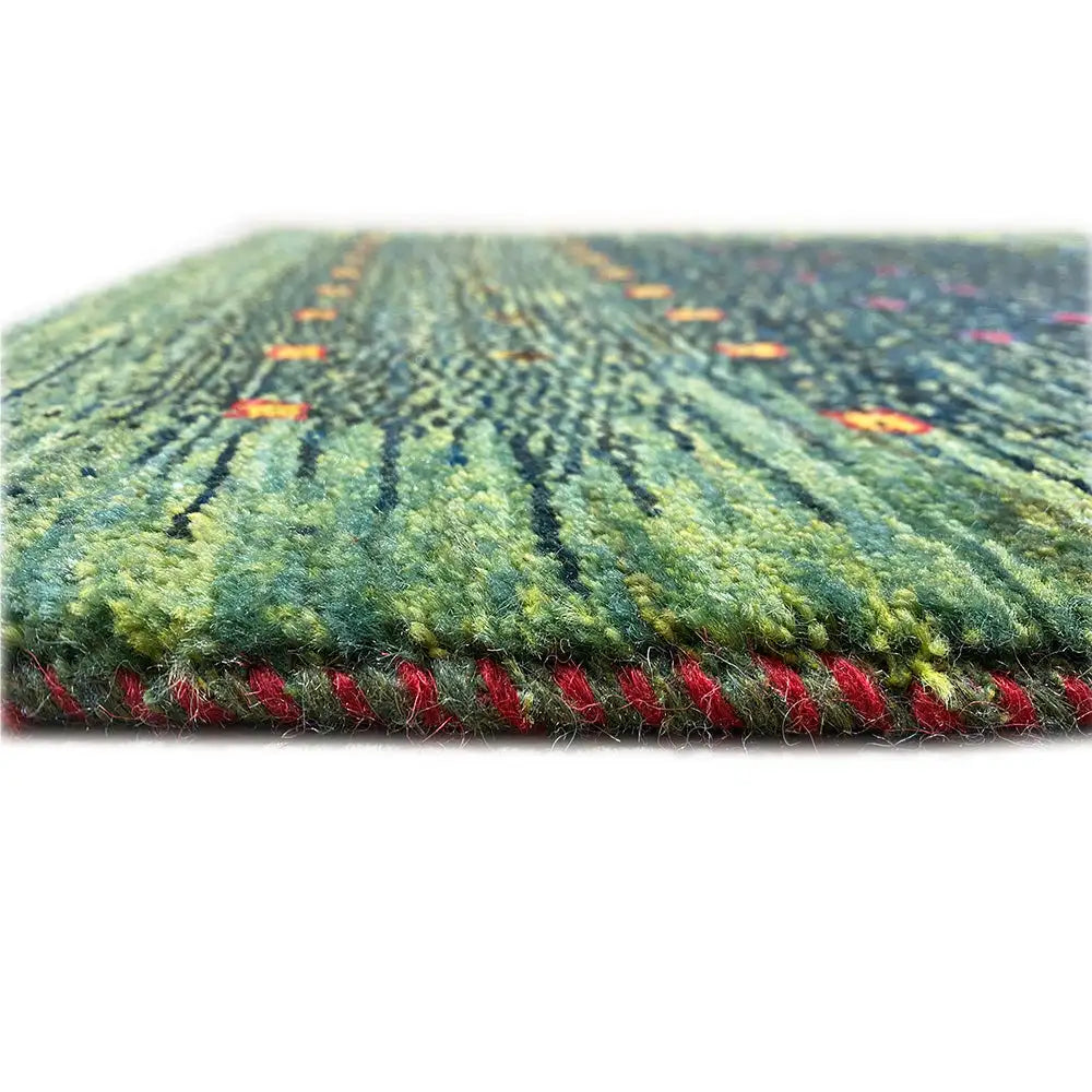 Gabbeh carpet Lori close-up at the edge: short fringes, green with colorful accents in the pile
