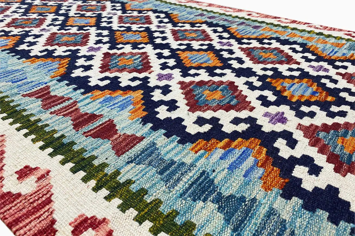 Close-up of the kilim runner: blue cross pattern with colorful accents and fringes