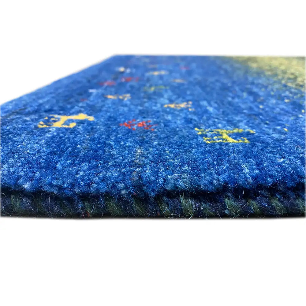 Gabbeh rug Lori (85x61 cm): close-up of the edge with a blue-green area and colorful animal motifs
