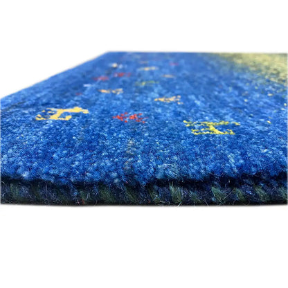 Gabbeh rug Lori (85x61 cm): close-up of the edge with a blue-green area and colorful animal motifs