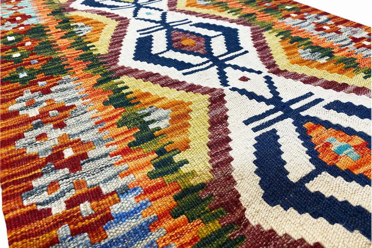 Afghan kilim runner close-up of the woven fabric with a stylized geometric pattern