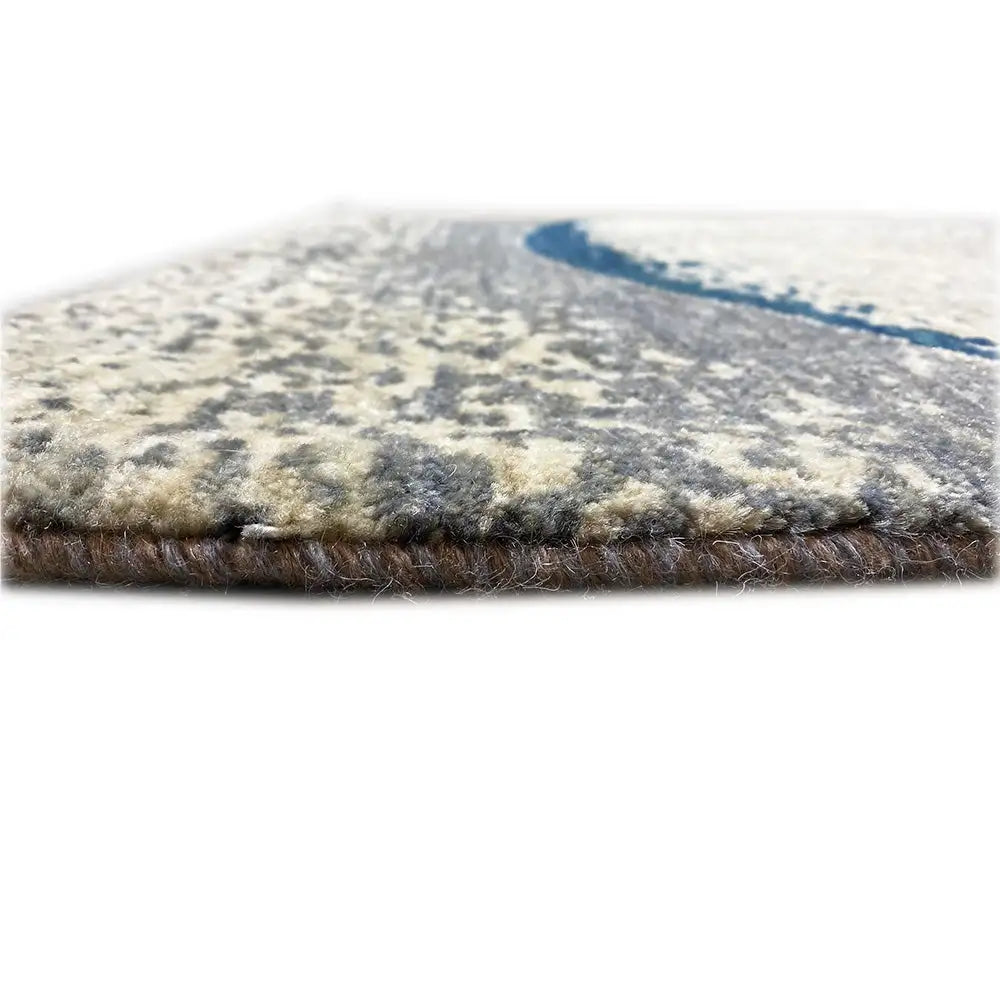 Gabbeh rug edge view with dense pile; light beige background, dark blue stripe