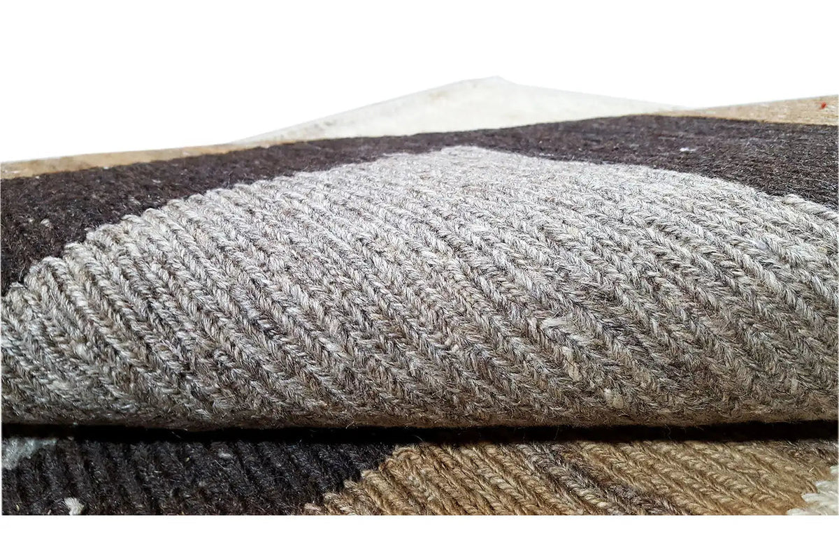 Woven rug detail of the weave structure and pile, gray, brown, and dark