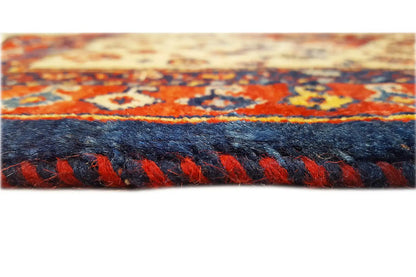 Qashqai exclusive rug edge with fringe, red-and-blue pattern along the border