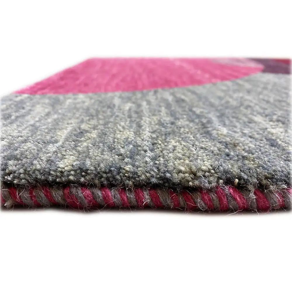 Gabbeh rug view of the selvedge: pile and fringe in gray, magenta, and red