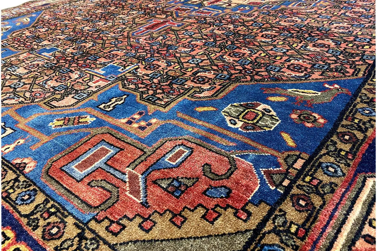 Hamadan rug detail with a blue field and red/yellow ornaments