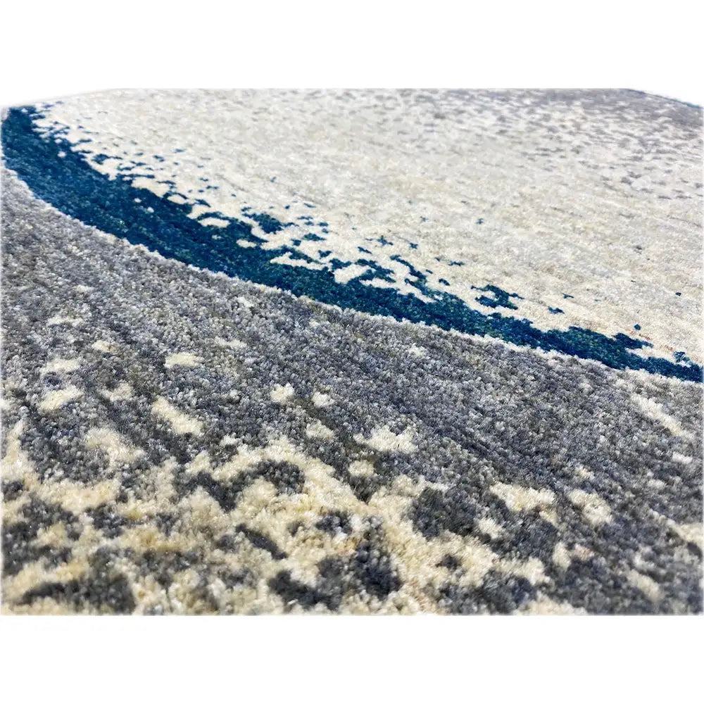 Details of the Gabbeh rug: pile structure, light beige and gray areas with a dark blue line