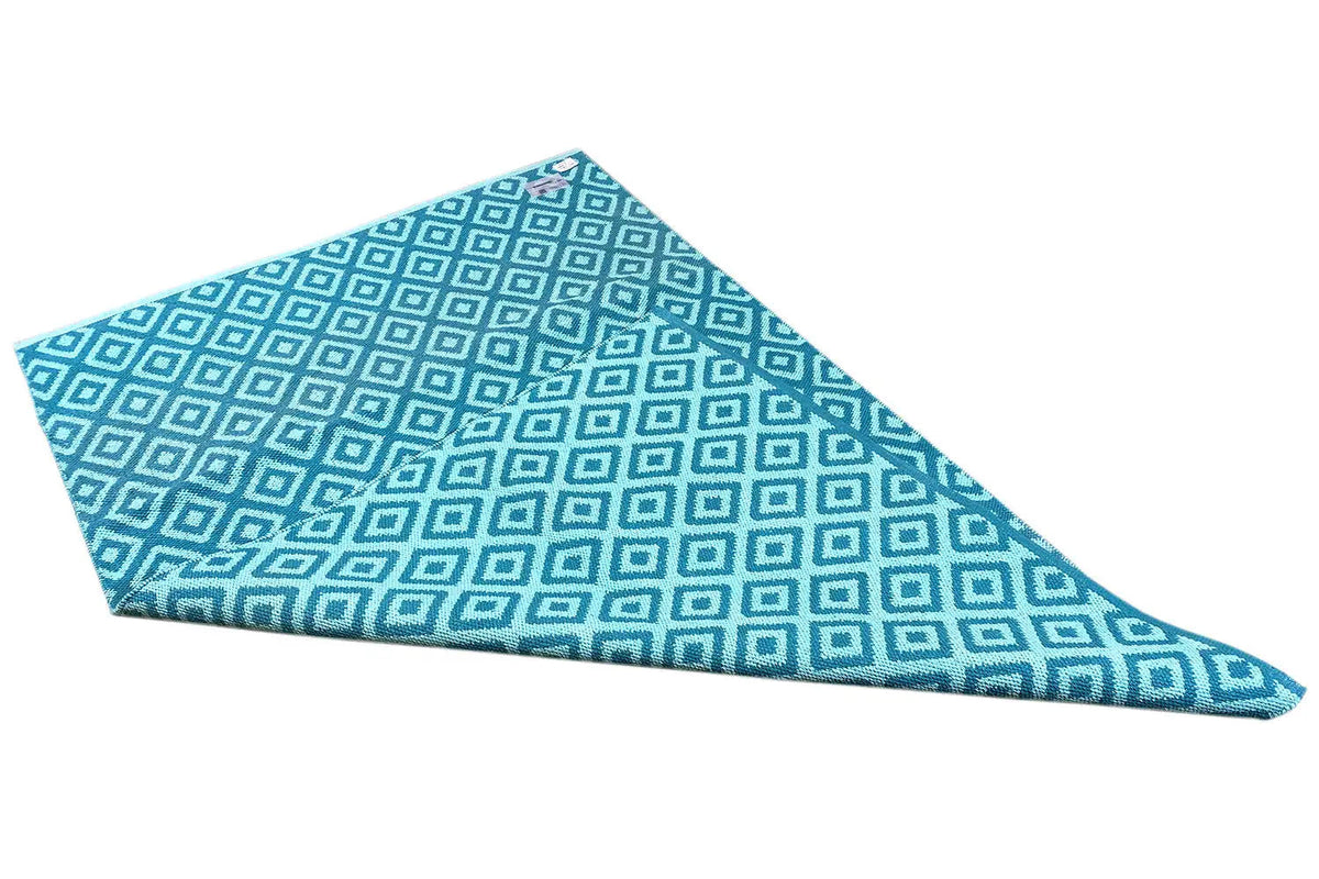 Blue kilim with a geometric grid pattern and visible edge stitching