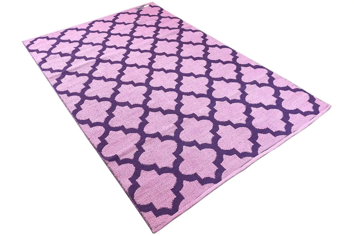 Diagonally draped kilim, purple pattern with pink clover elements in the repeat