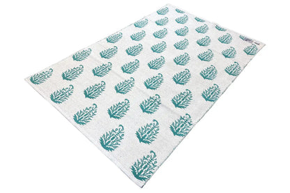 Modern kilim rug with a beige background and turquoise tree pattern, diagonal