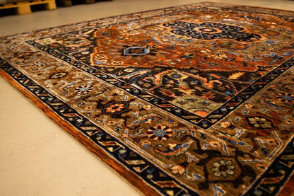 Ornamental rug with a multicolored pattern, dark central medallion, and border