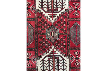 Close-up of the Hamadan runner: red field with a symmetrical pattern and white borders