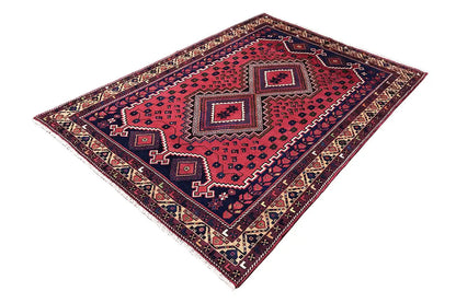 Rectangular rug with a red pattern, blue central field, and multicolored border trim