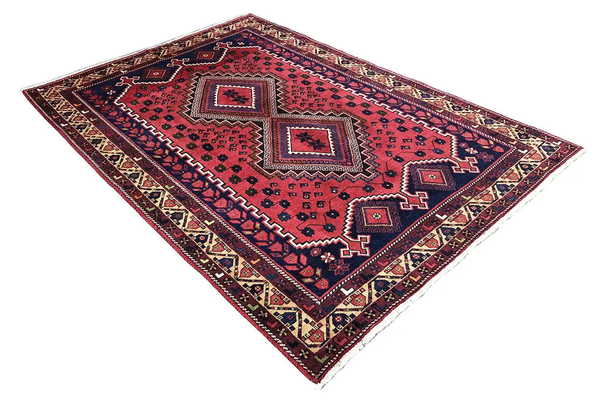 Oriental rug with a red background, dark blue interior, ornamental lattice, and decorative borders