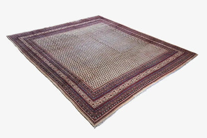 Rug with multicolored borders in blue and red on a light background