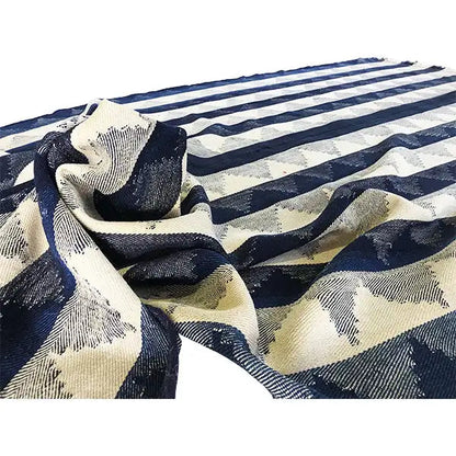 Jajim rug detail: dark blue and beige in a striped pattern, shown folded