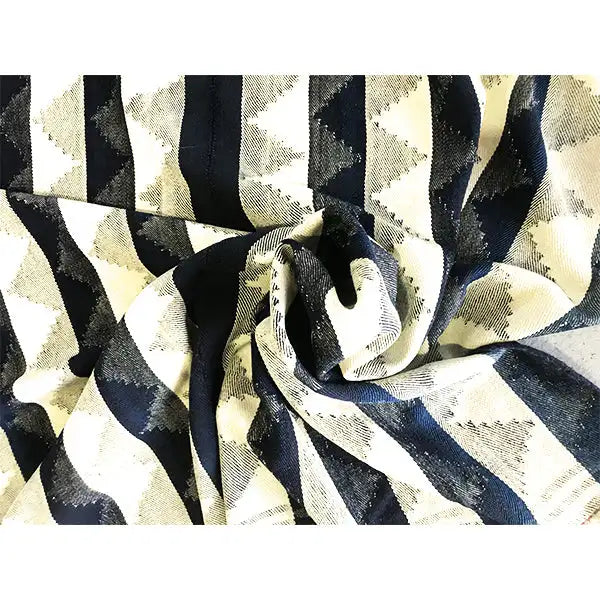 Close-up of a jajim rug: blue-beige stripes with a woven texture, rolled up