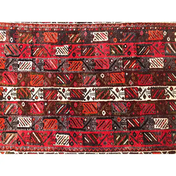 Rug with a red, black, and beige geometric pattern, patterned throughout