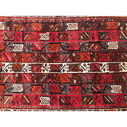 Rug with a red, black, and beige geometric pattern, patterned throughout