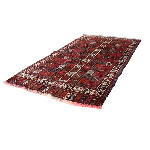 Rectangular rug with a red, black, and beige vine and ornamental pattern, fringes