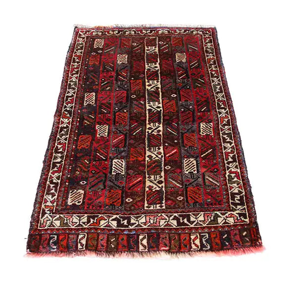 Carpet with a red background, black patterned field, and beige borders, with a square-looking design