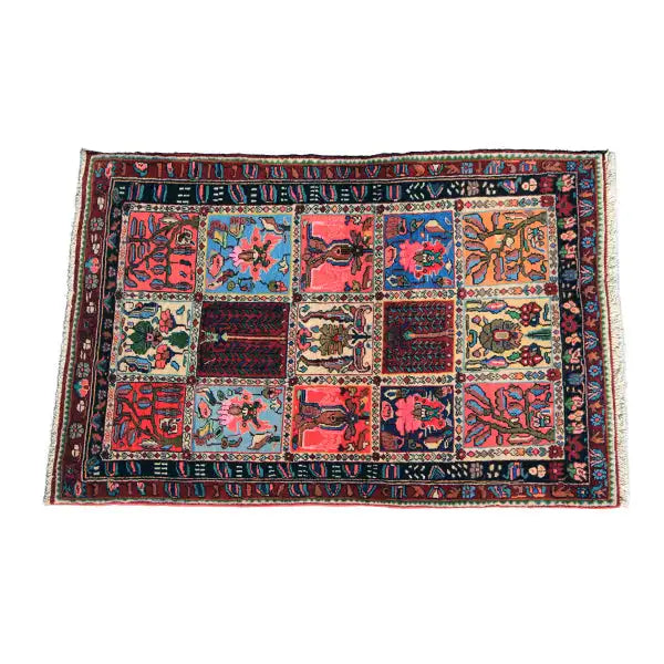 Rectangular rug with patchwork motifs in red, blue, green, and yellow, complete