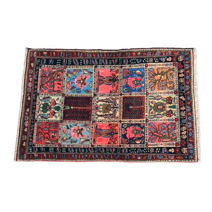 Rectangular rug with patchwork motifs in red, blue, green, and yellow, complete