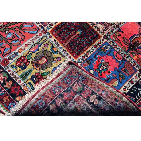 Colorfully patterned rug with diagonal panels and decorative border, close-up