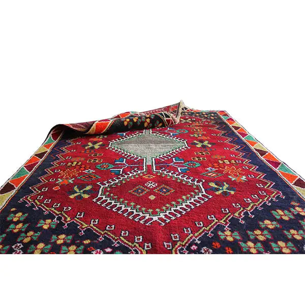 Rug with a red ornamental pattern, multicolored decorative borders, and fringes