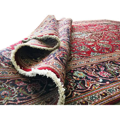 Keshan rug with a red background, ornaments, and a folded edge with fringes