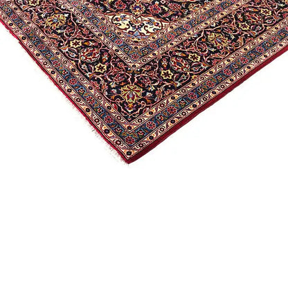 Keshan carpet corner with red edges, a dark background, and a fine ornamental border