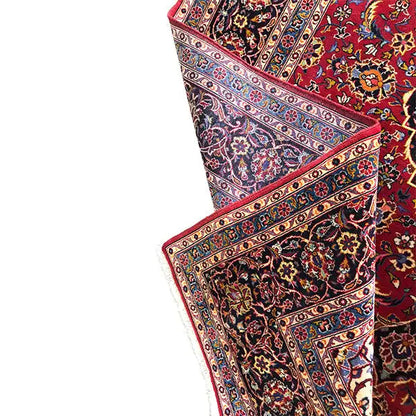 Keshan rug edge detail with a border stripe in blue, red, and cream
