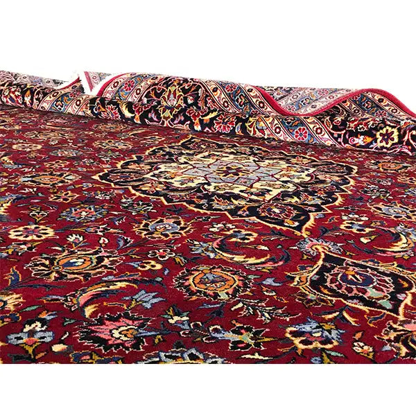 Carpet surface with a burgundy background and colorful floral ornaments