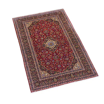 Burgundy red rug with a central medallion, multi-layered border, and ornaments