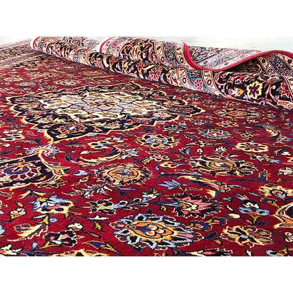 Rug with a twisted-pattern area and a burgundy background, intricate ornaments